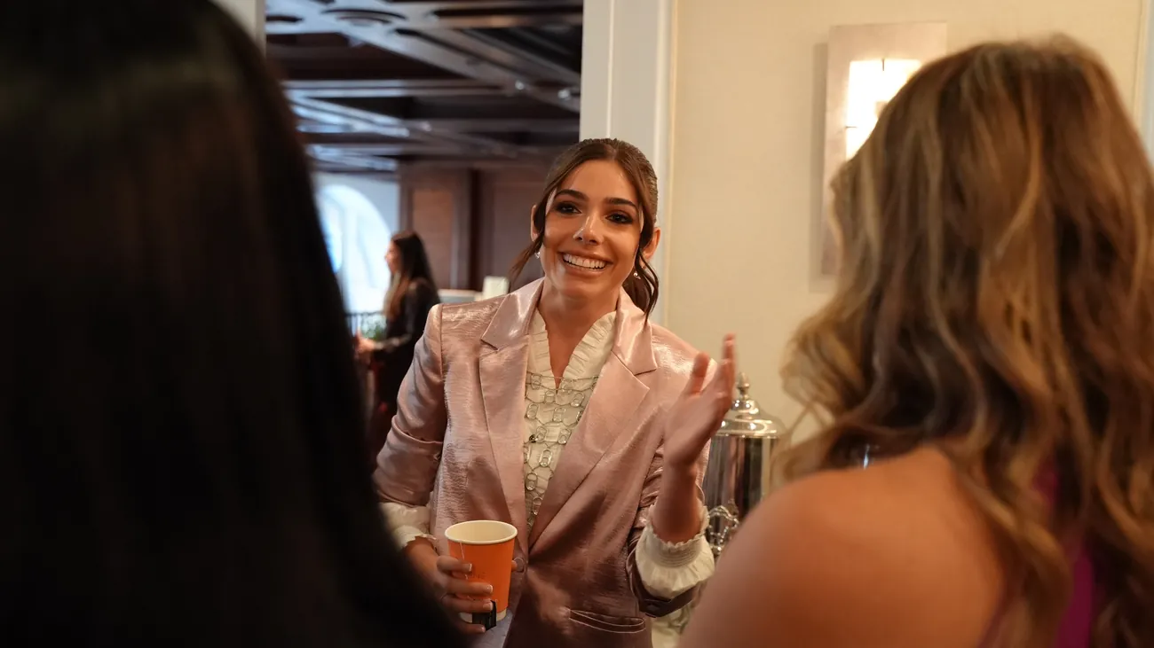 Taylor Price talking with attendees at an event