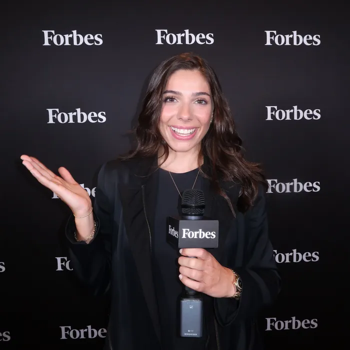 Taylor Price hosting at a Forbes event